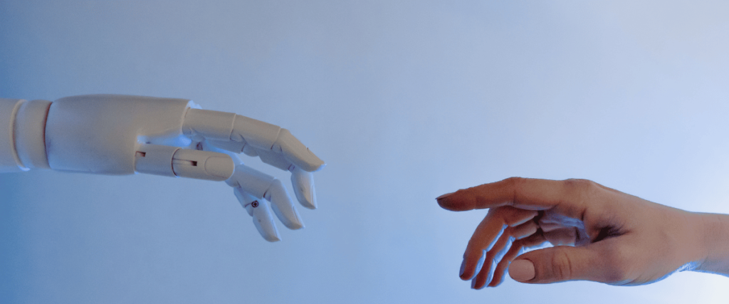 hand of a robot trying to touch the hand of human to help in humanitarian work